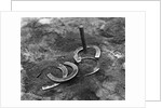 Horseshoes Around Pole by Anonymous