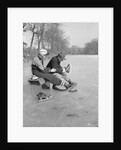 Man Puts Ice Skates On Woman At Rink by Anonymous