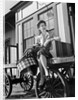 Woman Sitting on Luggage Trolley by Anonymous