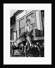 Woman Sitting on Luggage Trolley by Anonymous