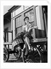 Woman Sitting on Luggage Trolley by Anonymous