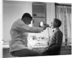 Doctor Examining Boy Patient by Anonymous