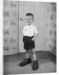 Boy Standing in Oversized Shoes by Anonymous