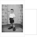 Boy Standing in Oversized Shoes by Anonymous