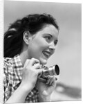 Woman Smiles as She Holds Camera by Anonymous