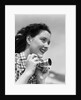 Woman Smiles as She Holds Camera by Anonymous