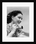 Woman Smiles as She Holds Camera by Anonymous