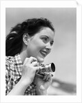 Woman Smiles as She Holds Camera by Anonymous
