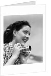Woman Smiles as She Holds Camera by Anonymous