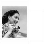 Woman Smiles as She Holds Camera by Anonymous