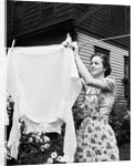 Woman Hanging Laundry Out to Dry by Anonymous