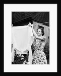 Woman Hanging Laundry Out to Dry by Anonymous