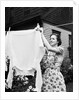 Woman Hanging Laundry Out to Dry by Anonymous