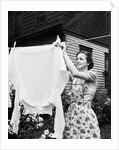 Woman Hanging Laundry Out to Dry by Anonymous