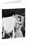 Woman Hanging Laundry Out to Dry by Anonymous