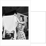 Woman Hanging Laundry Out to Dry by Anonymous