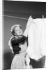 Woman Hanging Laundry by Anonymous