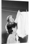 Woman Hanging Laundry by Anonymous