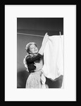 Woman Hanging Laundry by Anonymous