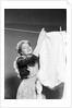 Woman Hanging Laundry by Anonymous