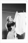 Woman Hanging Laundry by Anonymous