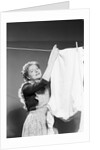 Woman Hanging Laundry by Anonymous