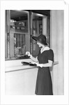 Woman At Bank Teller Window by Anonymous