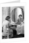 Young Woman Applying Face Cream at Vanity by Anonymous