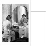 Young Woman Applying Face Cream at Vanity by Anonymous