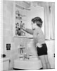 Boy Reaching into Medicine Cabinet by Anonymous