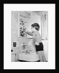 Boy Reaching into Medicine Cabinet by Anonymous