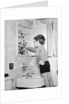 Boy Reaching into Medicine Cabinet by Anonymous