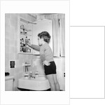 Boy Reaching into Medicine Cabinet by Anonymous