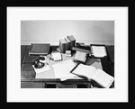 Desk Covered with Assorted Office Supplies by Anonymous