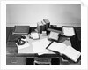 Desk Covered with Assorted Office Supplies by Anonymous