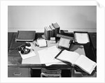 Desk Covered with Assorted Office Supplies by Anonymous