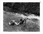 Boy Fishing with Hat Over Face by Anonymous
