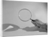 Hand Holding a Magnifying Glass by Anonymous