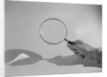 Hand Holding a Magnifying Glass by Anonymous