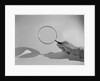 Hand Holding a Magnifying Glass by Anonymous