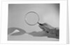 Hand Holding a Magnifying Glass by Anonymous