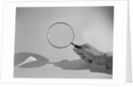 Hand Holding a Magnifying Glass by Anonymous