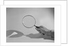 Hand Holding a Magnifying Glass by Anonymous