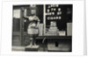 Wooden Statue In Front Of Cigar Shop by Anonymous