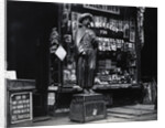Wooden Statue In Front Of Shop Window by Anonymous