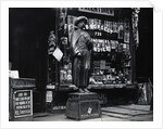 Wooden Statue In Front Of Shop Window by Anonymous