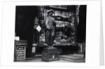 Wooden Statue In Front Of Shop Window by Anonymous
