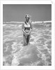 Woman Standing in Ocean Surf by Anonymous