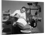 Dentist Working On Patient by Corbis