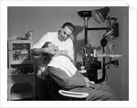 Dentist Working On Patient by Corbis